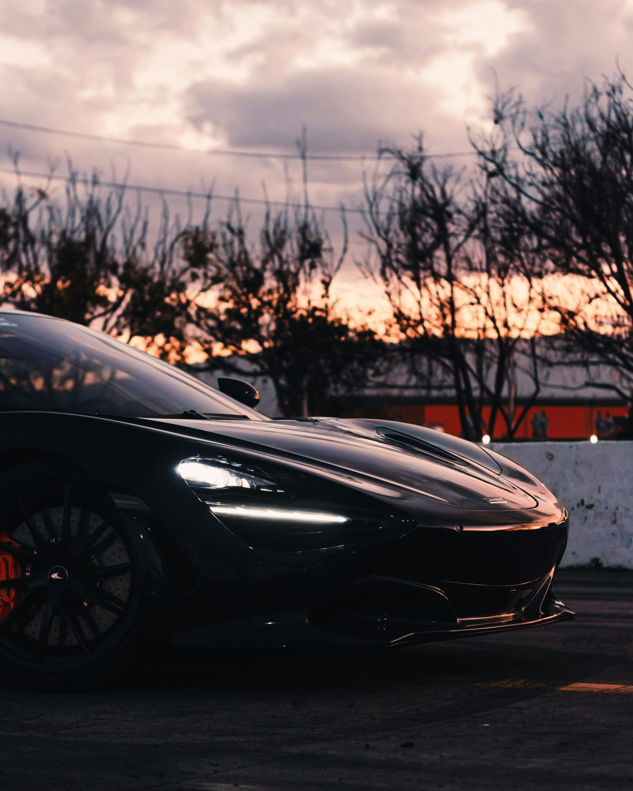 Stunning black supercar parked outdoors at sunset in Zapopan, Mexico, showcasing luxury and style.